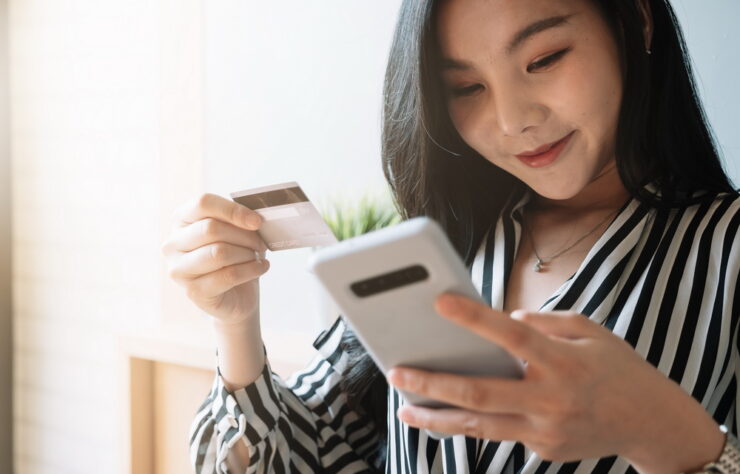 close up woman using smartphone and credit card for pay online shopping e-commerce online payment concept